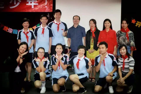 Red scarves, the kind Chinese schoolchildren wear.