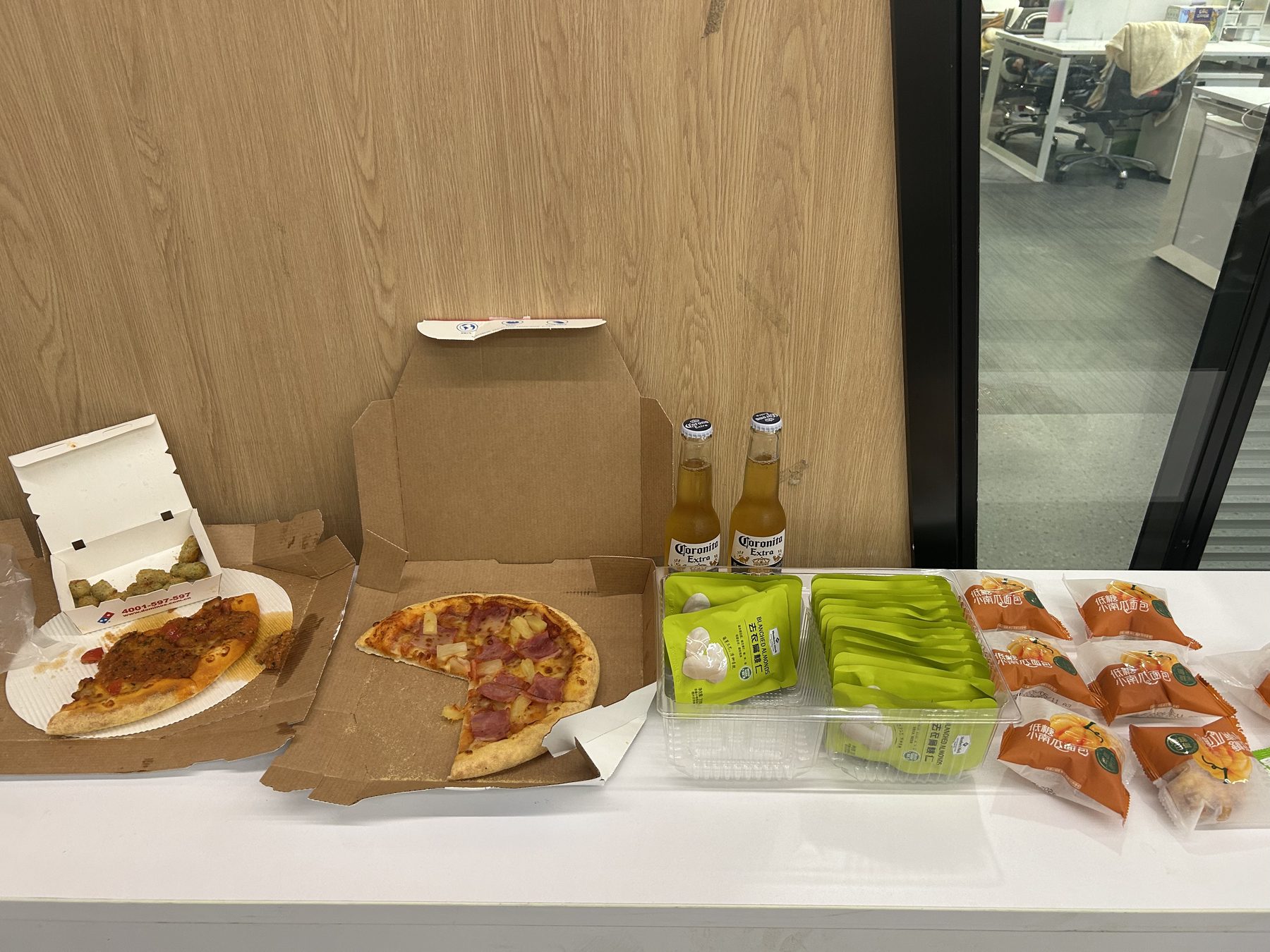 Domino's pizza, Corona, almonds, and pumpkin bread.