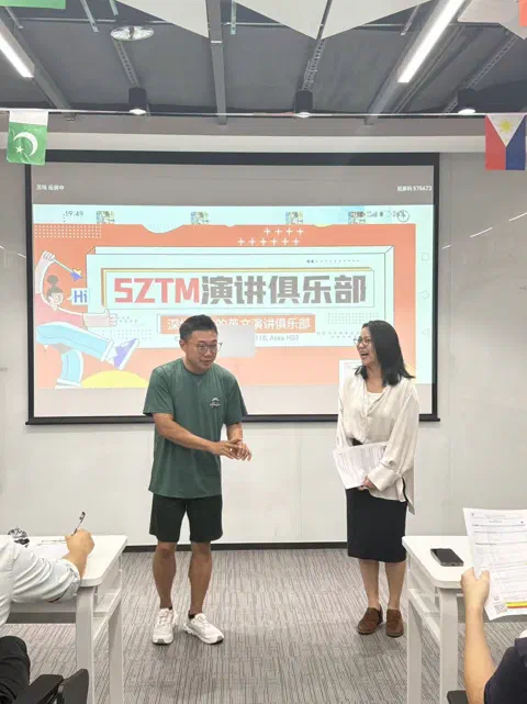 Another handshake on the Table Topics floor.