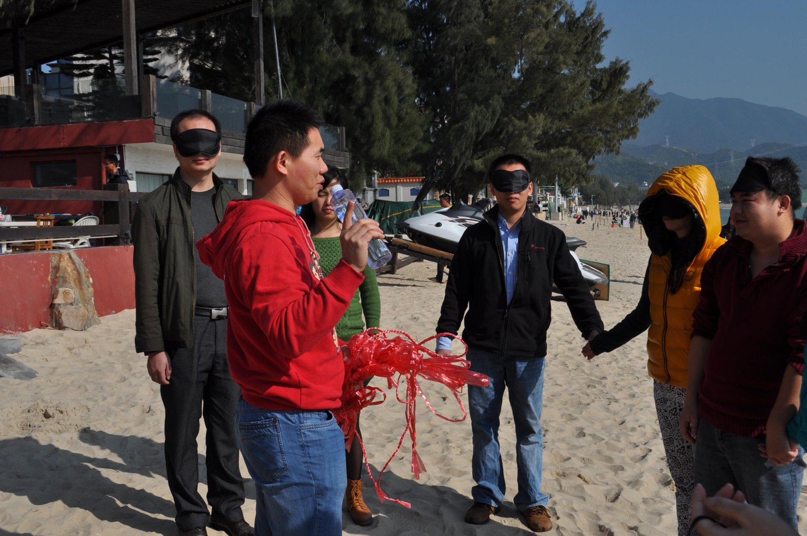 One of the two beach games: one person blindfolded, their partner leading them.